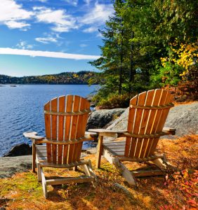 Muskoka chairs beside the lakeshore